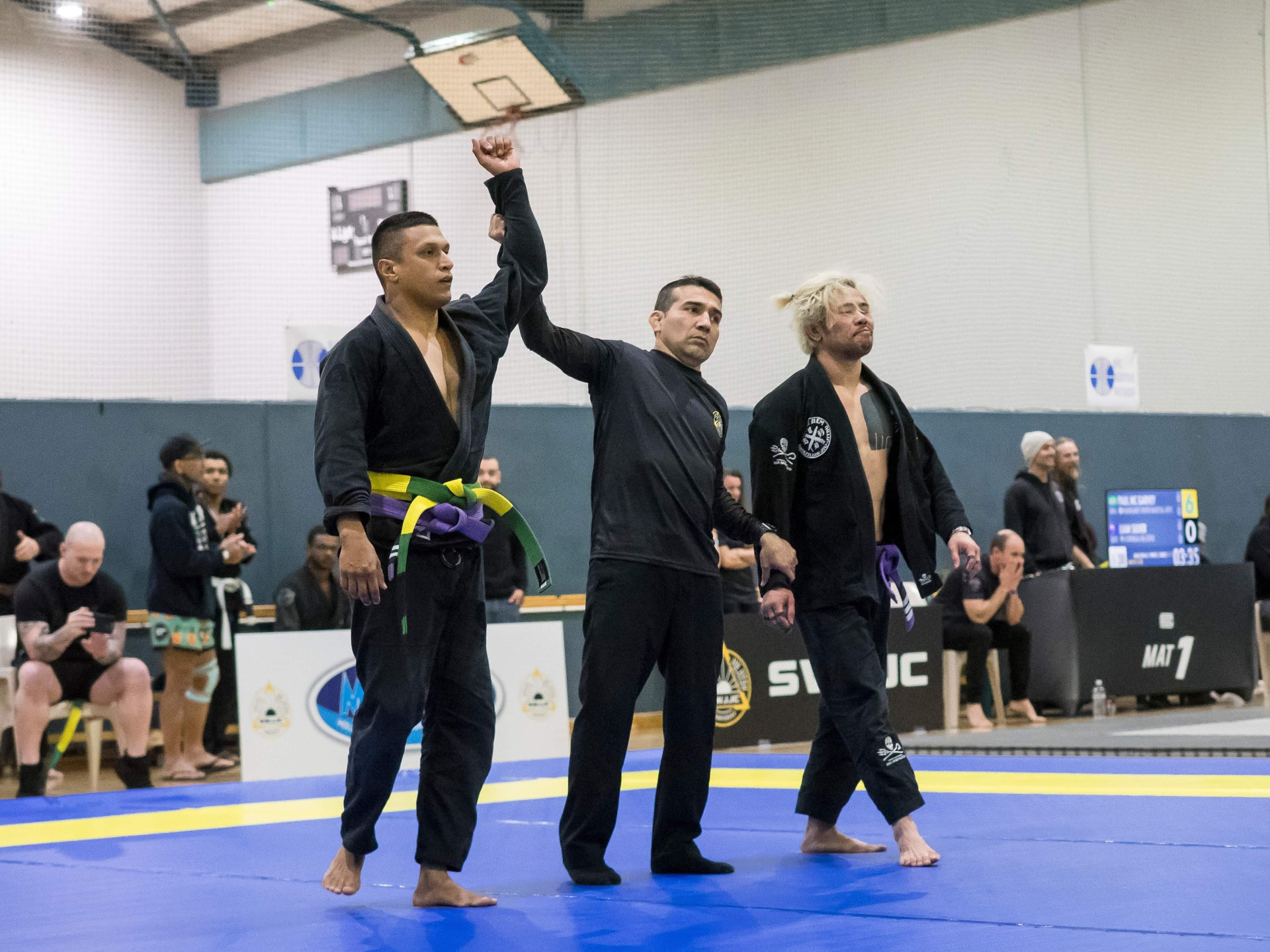 A Mat Shark competitor having his hand raised after a gi match