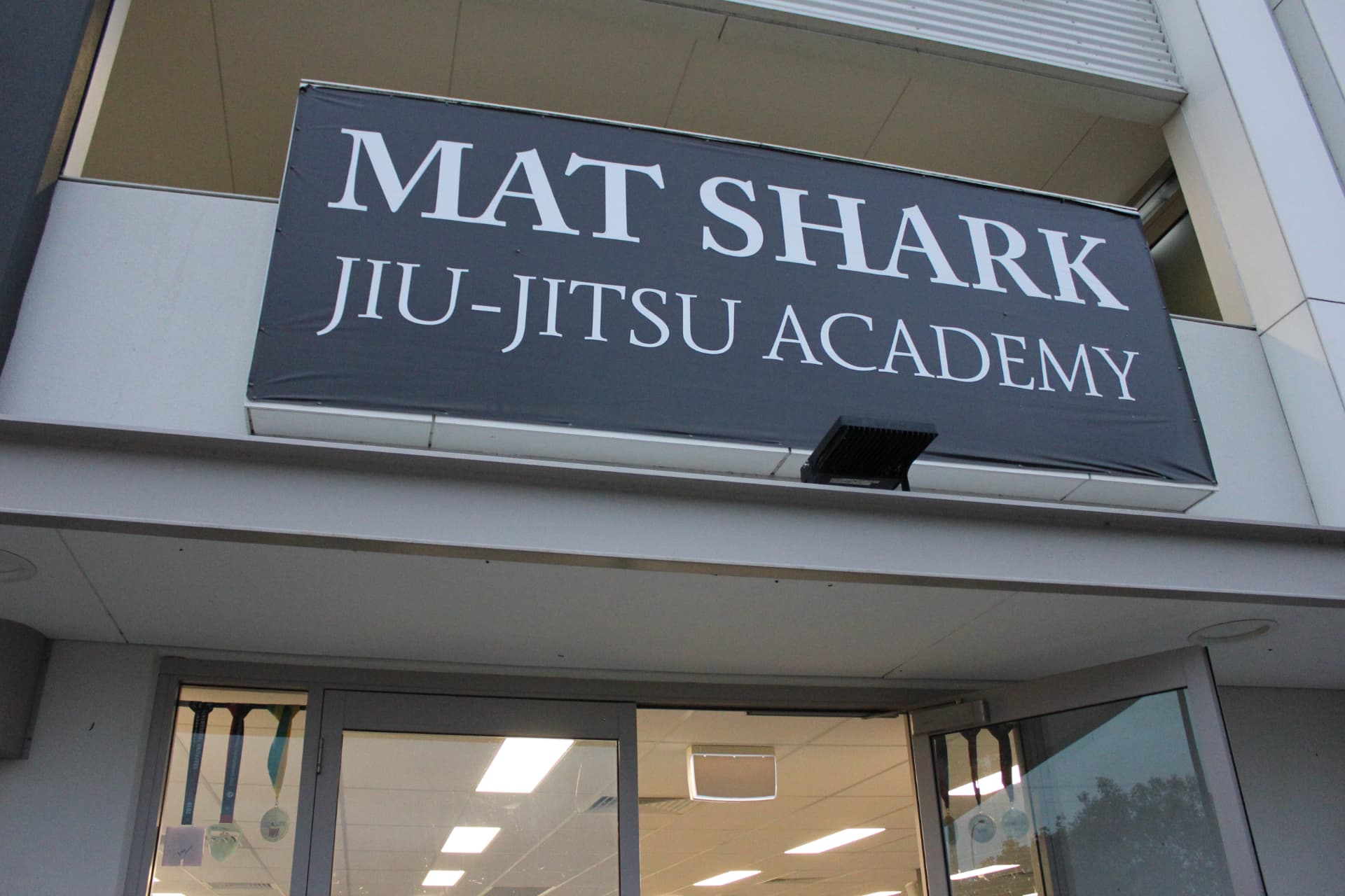 The Mat Shark Jiu-Jitsu Academy banner above the front doors