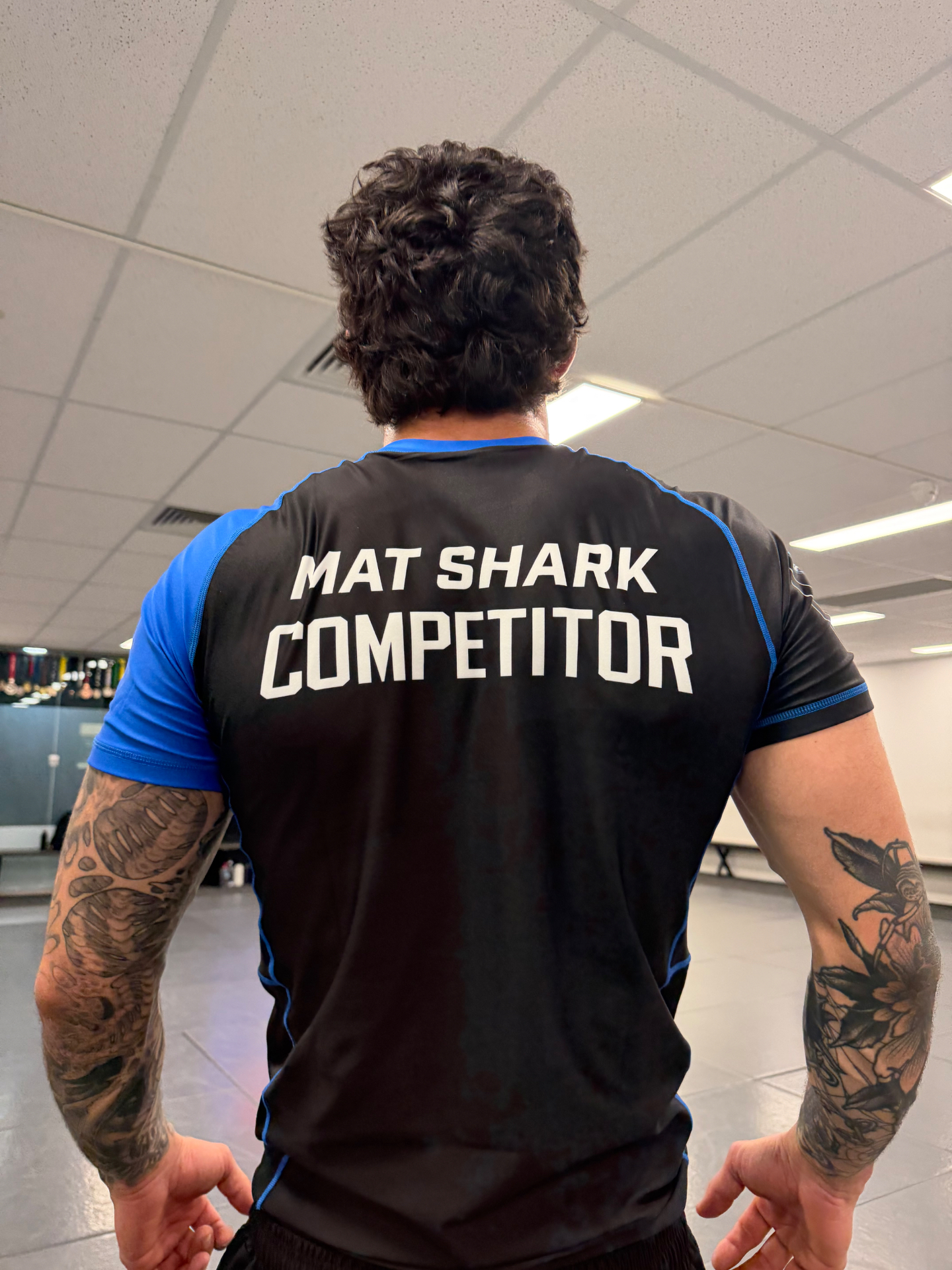 Mat Shark Competitor rash guard on a student inside the academy