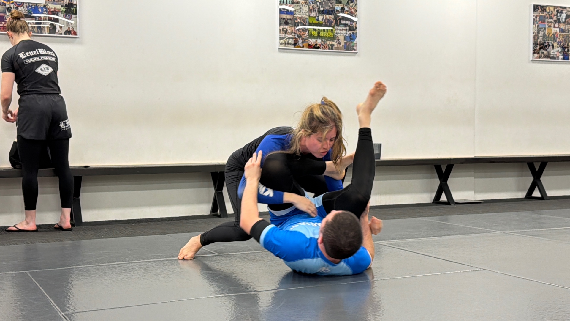 Two students working guard in a no-gi round at Mat Shark