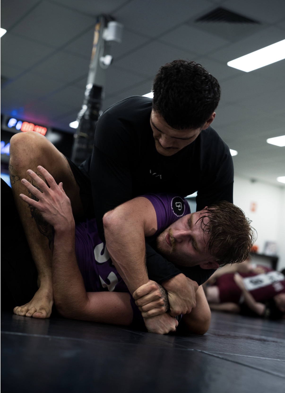 Two students in a no-gi round during an adults class
