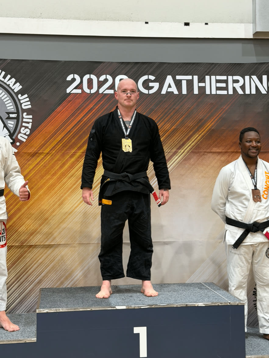 Adam Jacques taking gold on top of the podium at the 2026 Gathering