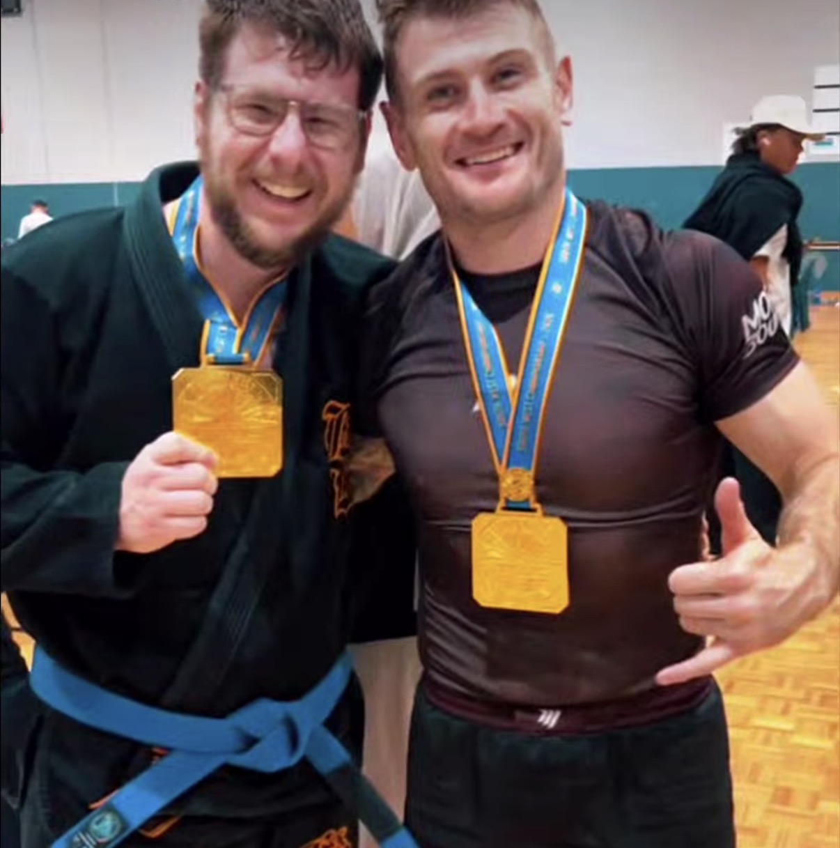 Two Mat Shark gold medallists celebrating at the SW Championship