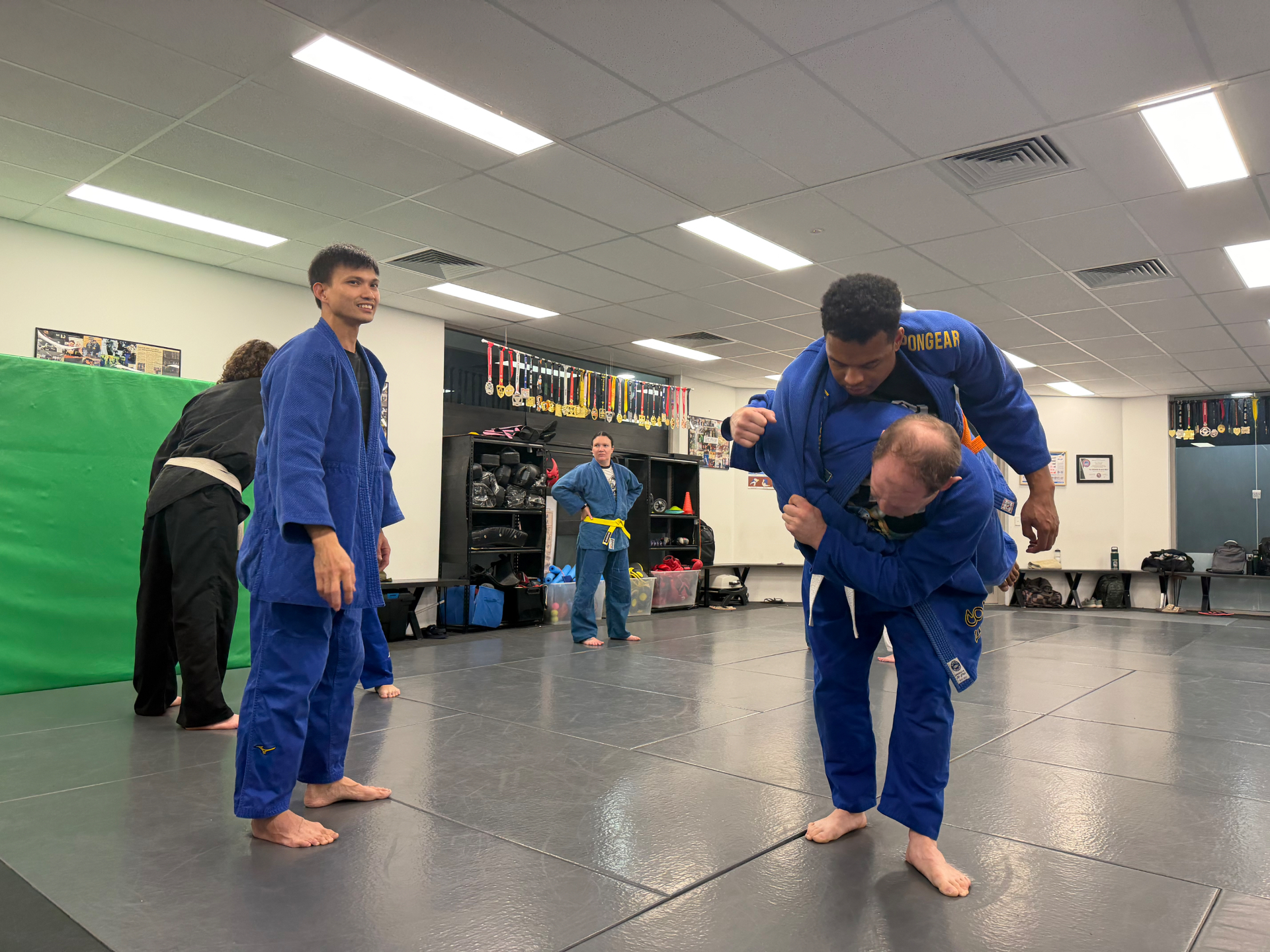 Judo students drilling a throw during a Mat Shark judo class