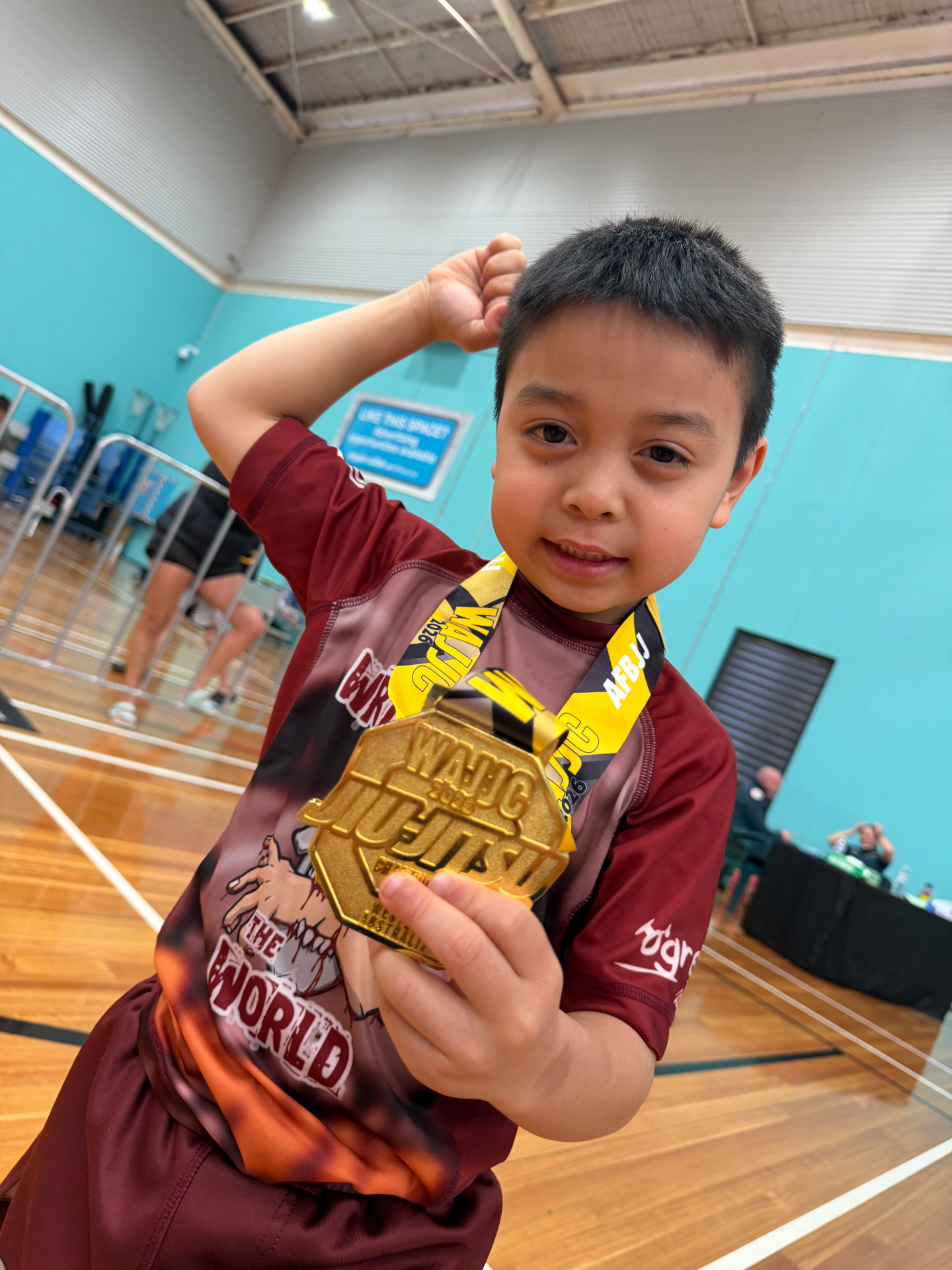 A young Mat Shark student showing off his WAJJC gold medal