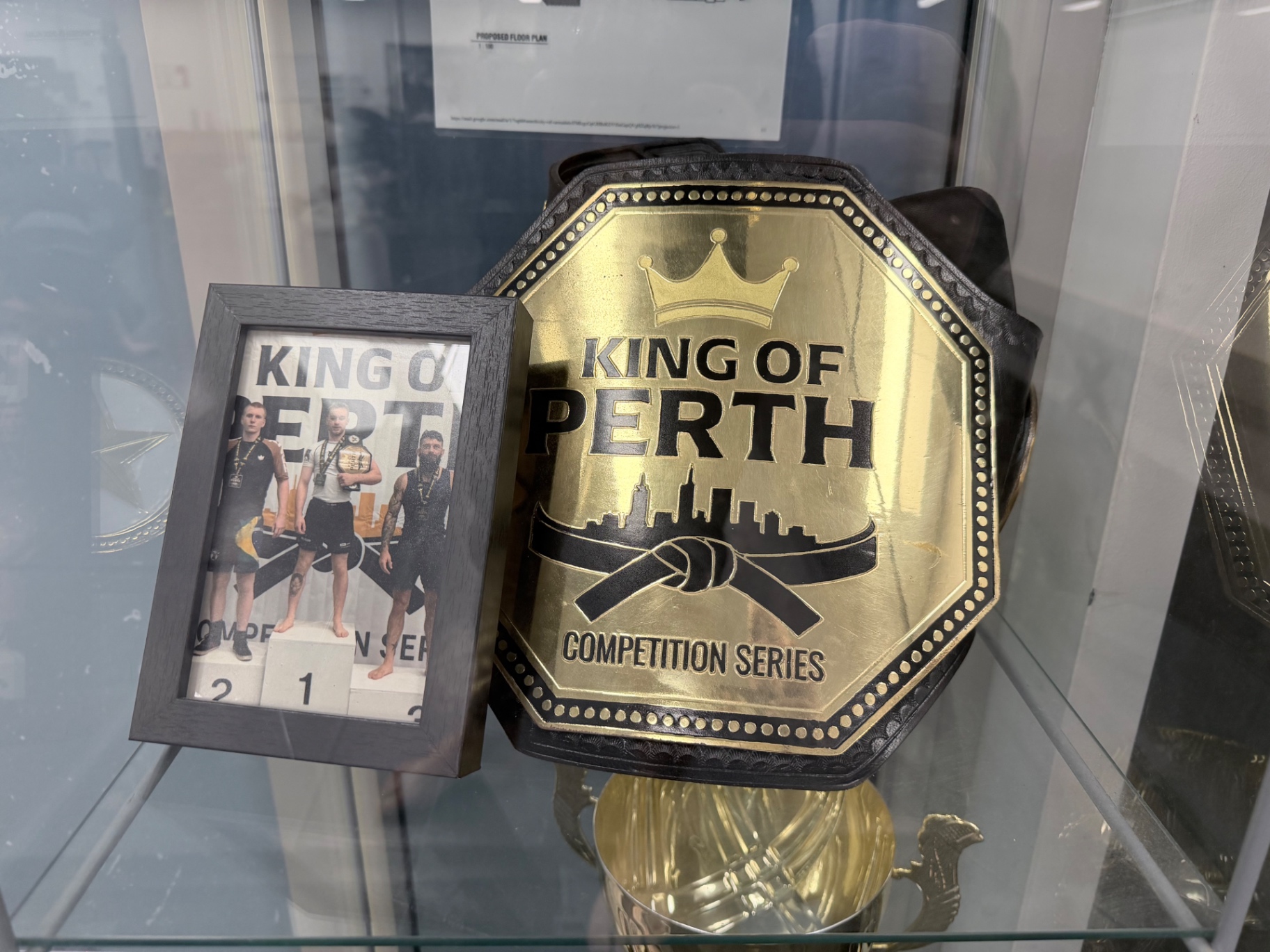 King of Perth competition series championship belt in the Mat Shark trophy cabinet