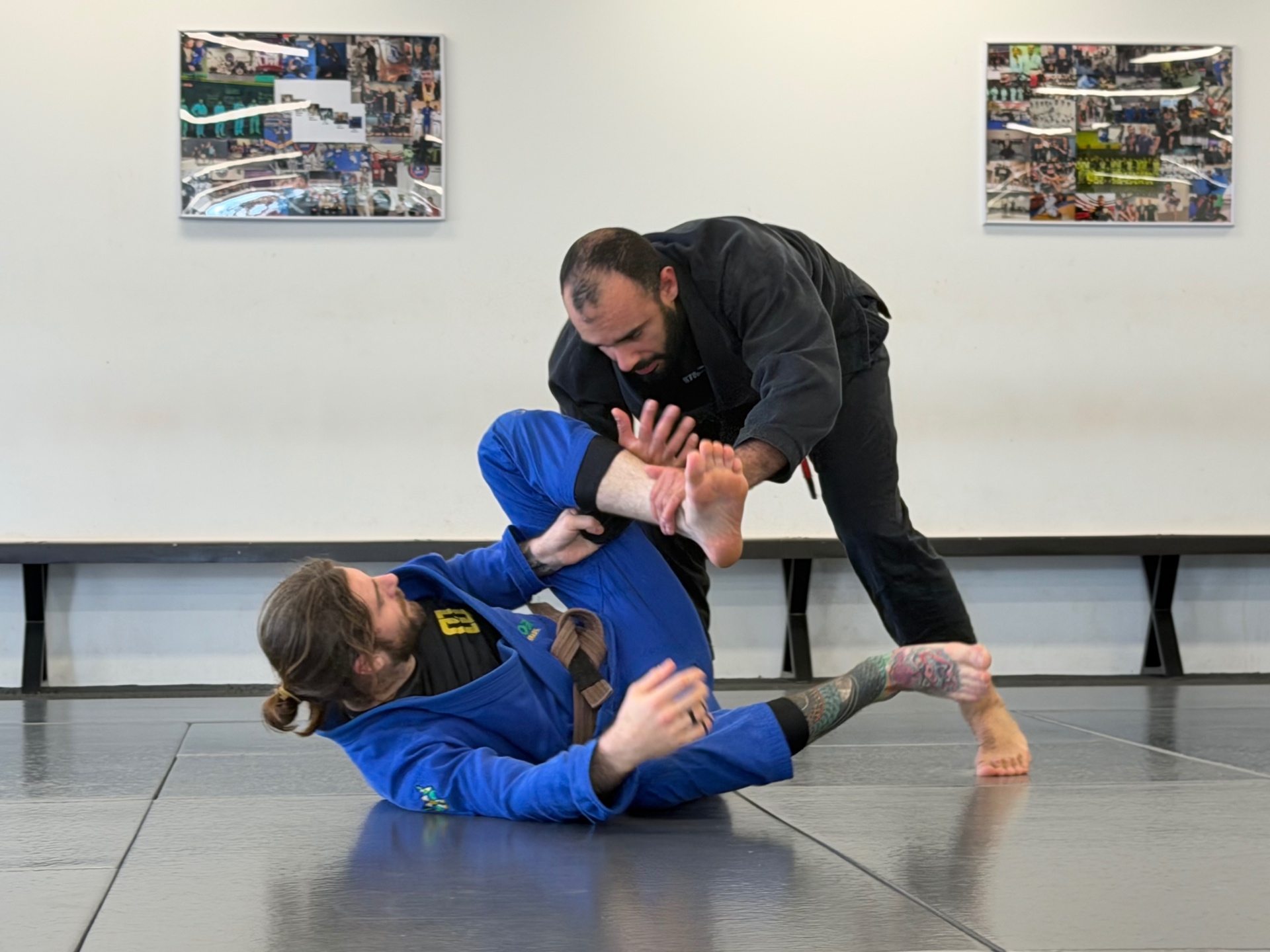 A coach passing guard in the gi during a class at Mat Shark