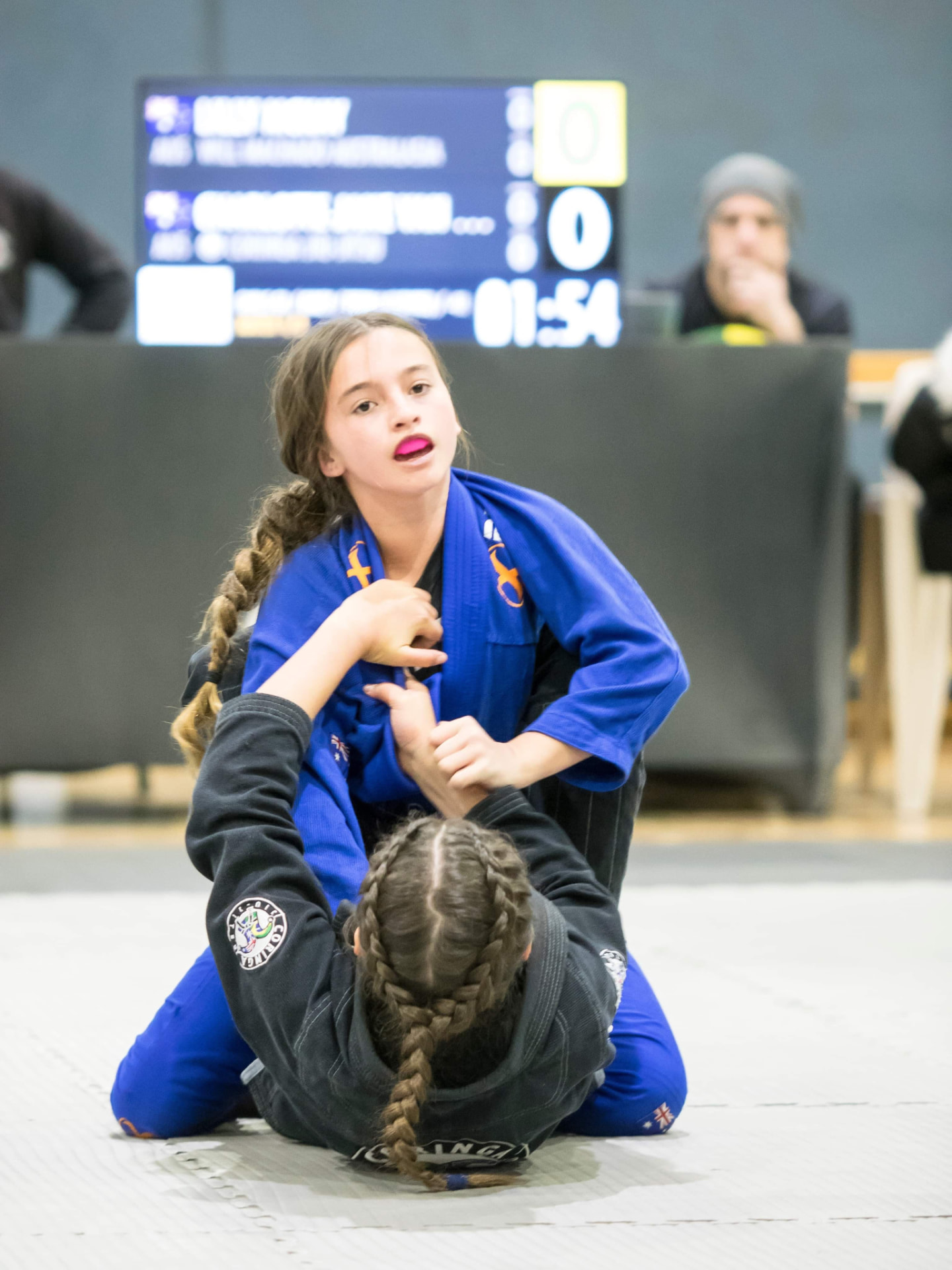 A young Mat Shark girl competing in the gi at a junior tournament