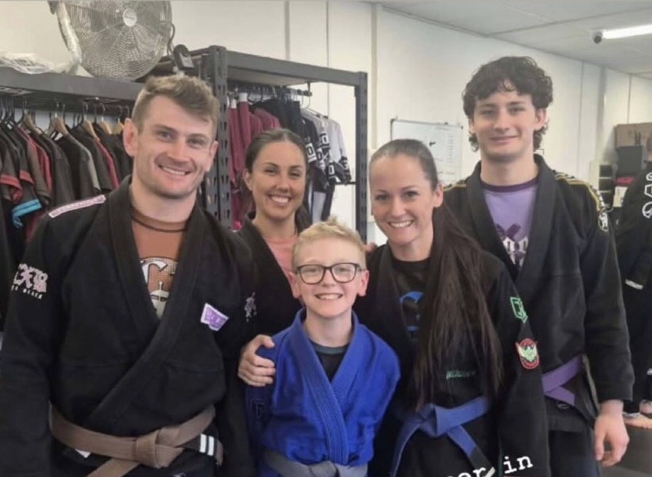 Mat Shark members and coaches smiling together after training